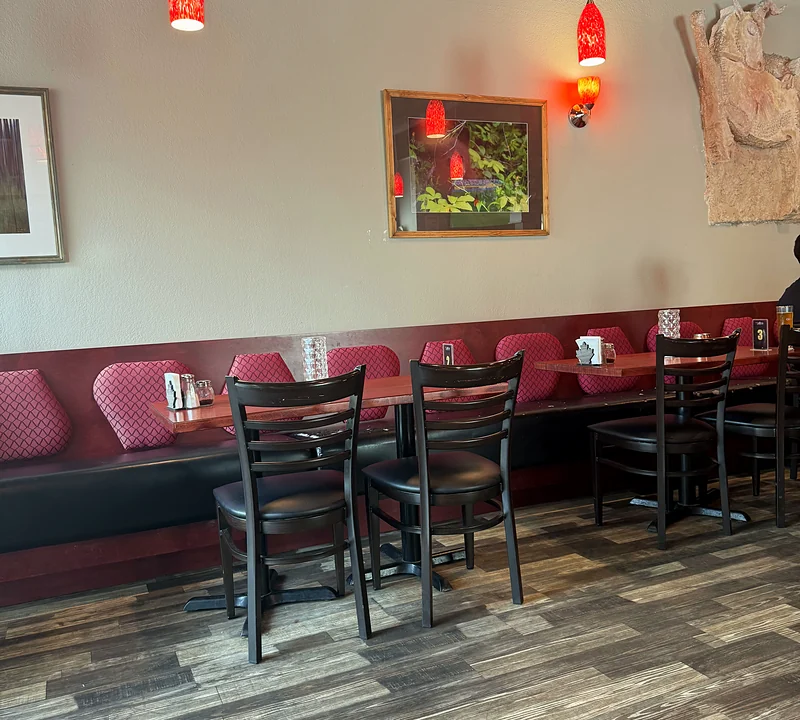 Booth seating and tables along the wall at Saffron