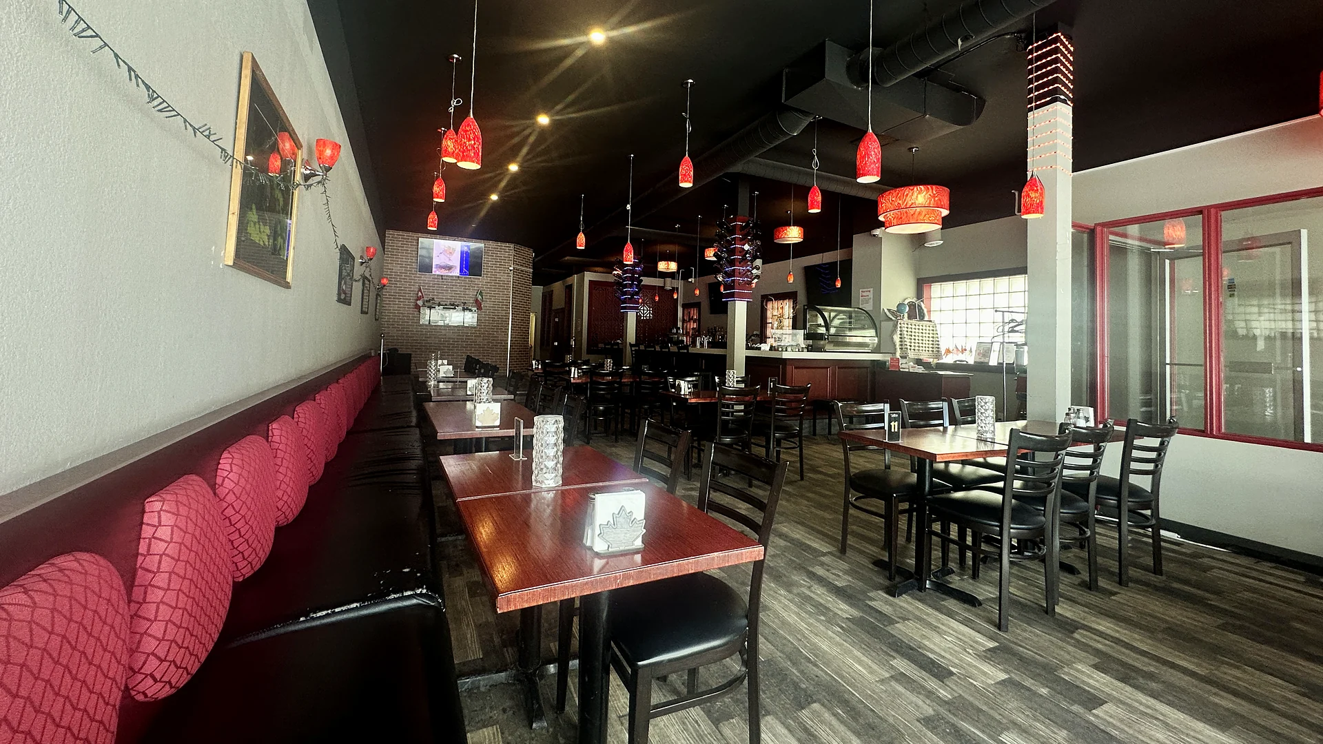 The dining room at Saffron with red glass pendant lights