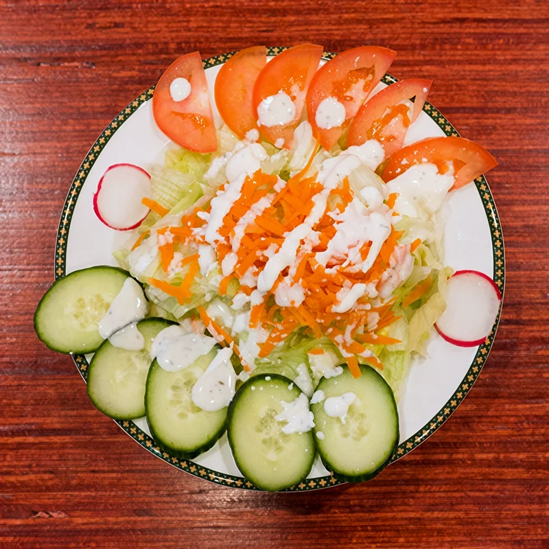 Season salad with lettuce, carrot, tomato, cucumber and radish