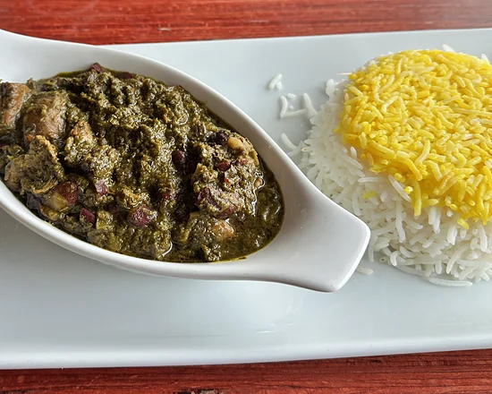 Khoresh ghormeh: herb stew with beef and kidney beans beside saffron rice and pickles